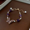 Close-up of butterfly pendant bracelet with purple beads and pearls in a jewelry gift box - Gold Purple (3# Bracelet-Butterfly)