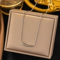 Minimalist silver curved tube necklace with a sleek snake chain in a jewelry box - Eggplant / Steel