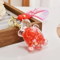 Macro view of a clear turtle keychain with red liquid and colorful sequins - Jelly Bean Red