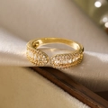Macro shot of 18K gold plated ring with zircons on elegant champagne satin fabric - Geometric Misaligned Row Zircon Ring