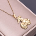 Close-up of gold stainless steel skull cherry pendant with 18k plating on pink box - Skull Cherry Shape (S1055) / Gold Color Necklace With Pendant