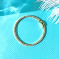Detail of gold tennis bracelet featuring pink zircon stones on a blue fabric background - Bracelet / Gold Bracelet 2mm