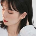 Close-up of elegant gold heart earrings worn by a model for a stylish French fashion look - Gold Heart Studs