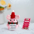 Close-up of a pink crochet rabbit with a Santa hat and a Merry Christmas support card - Christmas Rabbit + Card