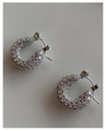 Macro shot of silver U-shaped earrings encrusted with sparkling zircon stones - Large / Silver