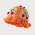 Detailed crochet texture of handmade kids knit bucket hat with cherry motif and ruffles - One Size / Orange