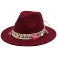 Close-up of ethnic style woven band with tassels and shells on dark red fedora hat - Burgundy