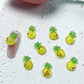 Detailed 3D yellow resin pineapple nail art charms on a textured white background - 06 Pineapple
