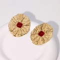 Macro shot of vintage gold earrings with irregular texture and red square enamel detail - Wine Red Square Inlay Style / Burgundy