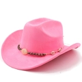 Detailed close-up of pink suede cowboy hat with ethnic beads and shell ornaments - Magenta