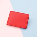 Slim red faux leather card holder with litchi texture and minimalist stitching detail - Red