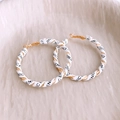Detail of gold hoop earrings with white leather wrap and black lettering on ceramic tray - Silver Pin-Gold-White