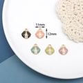 Macro detail of alloy pearl scallop shell charms in five colors with 11x12mm size markers - 1# Scallop / Black