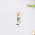 Detail of fairy keychain with blue dress and heart lobster clasp on white background - Blue