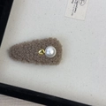 Close-up of brown plush drop-shaped hair clip featuring a white pearl and gold bead - Hair Clip / Khaki