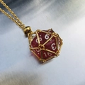 Unique gold metal cage necklace with a sparkling red d20 polyhedral dice pendant - Gold Cage with Dark Red Dice