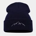 Detailed close-up of dark blue knit beanie featuring white mountain peak embroidery - Navy Blue