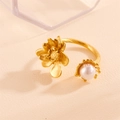 Golden titanium steel open ring featuring a 3D rose and pearl on textured surface - Gold