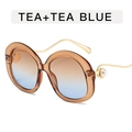 Grote ronde zonnebril met theekleurig montuur, blauwe verloopglazen en parelpoten - Thee + Thee Blauw