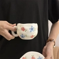 Hand-painted ceramic coffee mug featuring red roses and blue flowers with a cream base - Rose Blue Flower