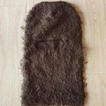 Dark brown furry knitted balaclava mask for outdoors displayed on a light wooden background - One Size / Coffee