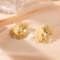 Elegant gold hollow flower stud earrings with a central crystal on silk background - Multi-petal Flower