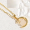 Close-up of gold crescent moon necklace with a white rabbit pendant and emerald zircon detail - Rabbit Necklace