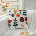 White square pillow with vibrant floral embroidery and green piping on a plush sofa - Pastoral Flowers (Cover Only)