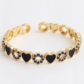 Adjustable gold bracelet with black enamel hearts and blue zircon pavé ring accents - Heart Embroidery Black