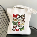 Detail of white canvas tote bag with butterfly print resting on a black chair - Butterfly Specimen-R61