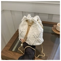Detail of white denim bucket bag with frayed quilted fabric, gold chain and pearl accent - Off White