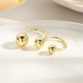 Detail of 18k gold plated double layered wire-wrapped ball rings on white ceramic tray - Gold U-shape Three Balls Style (ZYN-DMR170G)