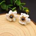 925 silver flower stud earrings with white petals and a deep blue pearl center - White Stone