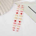 Pink and yellow press-on nails with red bows and heart patterns, model Q013 - Q013 Pink Yellow Bow Heart