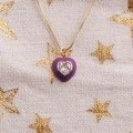 Close-up of purple heart pendant necklace with gold chain and inset crystal detail - Purple