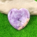 Heart-shaped purple amethyst worry stone on green grass for healing and meditation - Lilac Stone