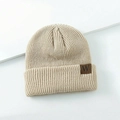 Knitted winter beanie for kids in beige with ribbed texture and brown leather W patch - One Size / Beige