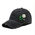 Close-up of vintage washed black cotton baseball cap with daisy flower embroidery - One Size / Black