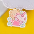 Cute brown bear acrylic badge with pink drink and star details on yellow background - Milk Tea Bear