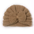 Detailed texture of camel knit baby turban hat featuring a large soft decorative bow - Light Coffee