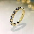 Detail of evil eye ring featuring gold plating and sparkling cubic zirconia stones - Gold-Black