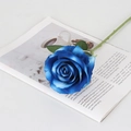 Elegant blue artificial velvet rose with green leaves on an open book for home decor - Large Velvet Blue