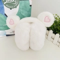 Close-up of white plush earmuffs featuring pink sequin heart embroidery on soft ears - One Size / White