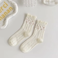 Detail of white cotton JK socks featuring ruffled edges and pink polka dot patterns - Pink Polka Dot Ruffle Style