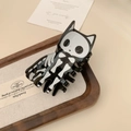Detail of Halloween cat skeleton hair claw clip on a wooden jewelry display tray - 7.8cm / Black