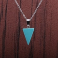 Macro shot of silver chain necklace with turquoise semi-precious stone triangle pendant - Turquoise Triangle