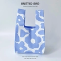 Detail of blue and white floral knitted tote bag showing intricate stitch texture - Blue Random Flowers