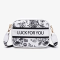 Chic white camera crossbody bag featuring black floral toile print and Luck For You text - Black