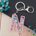 Letter N keychain with pink acrylic frame and colorful star glitter sequins inside - Letter N