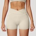 High-waisted beige yoga shorts with V-cross waistband and side pockets for workout - Oat Apricot